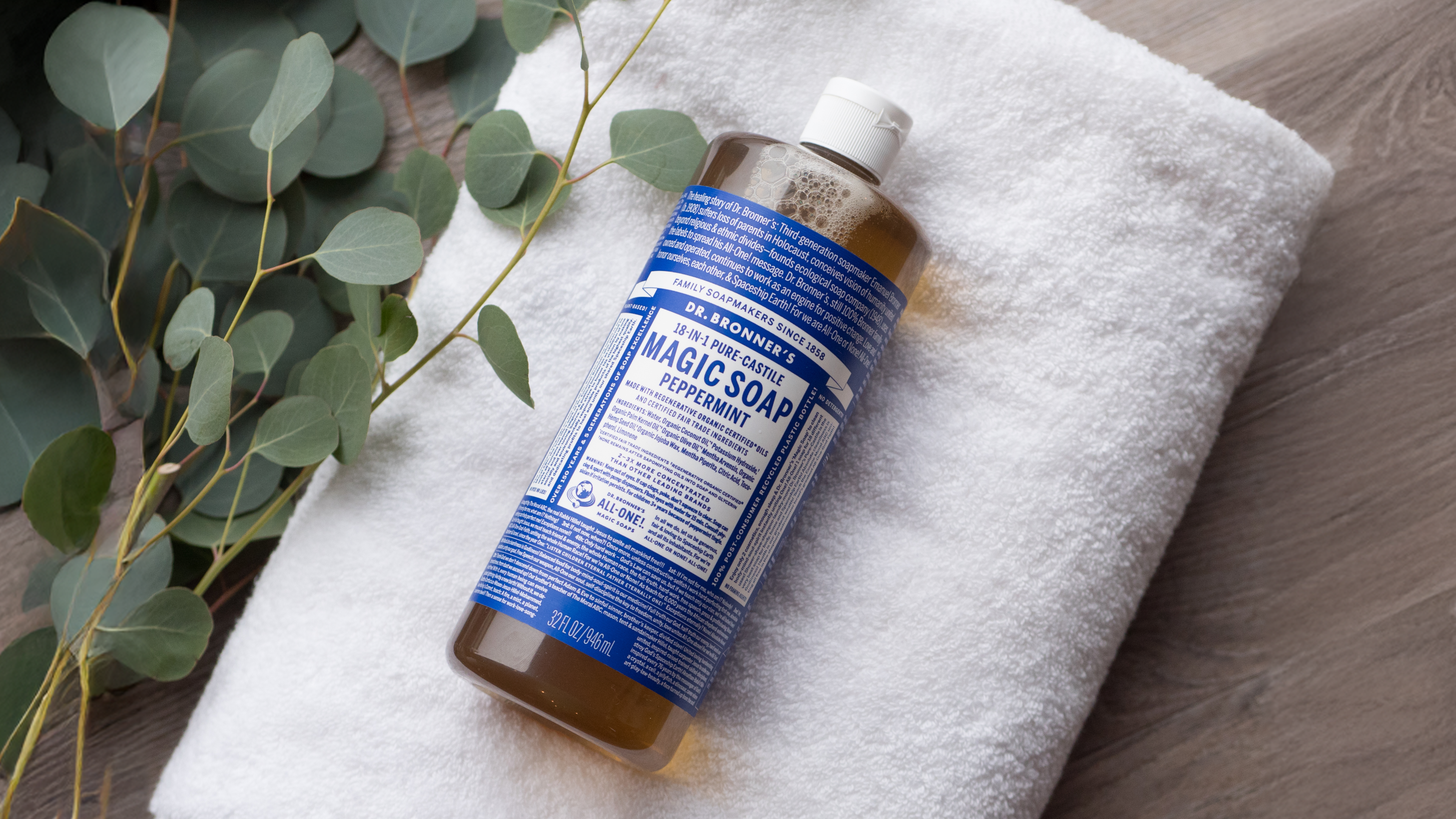 Dr. Bronner's Castile Magic Soap on towel on floor.