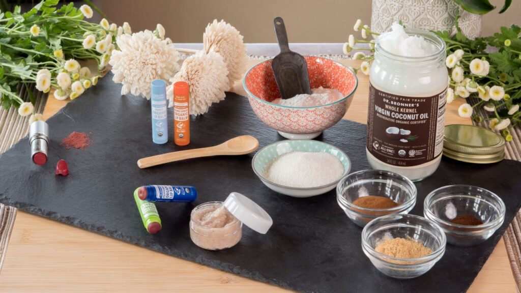 Ingredients for making a lip scrub & lip tint with Dr. Bronner's laid out on a table