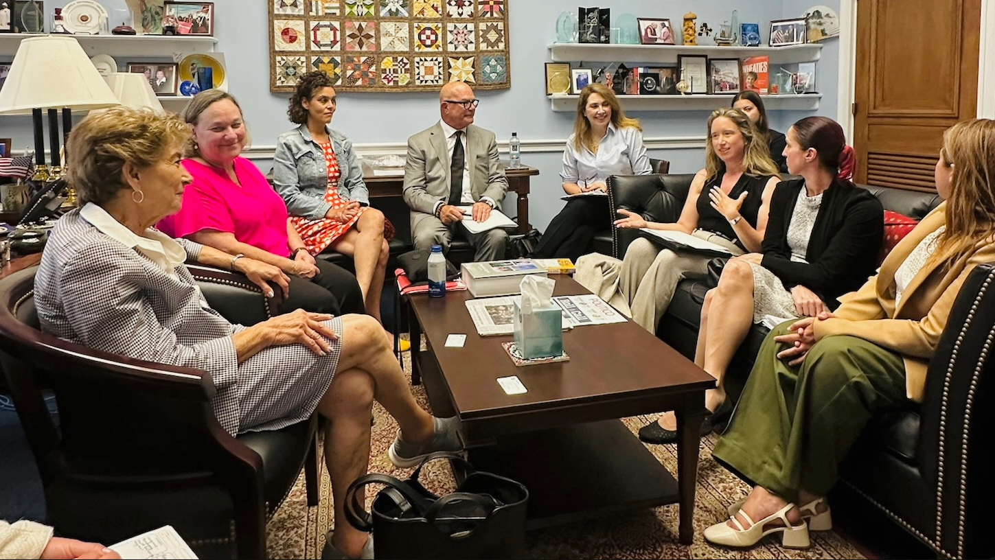 A room full of people that came to Advocacy Day sitting on couches and chairs in a circle discussing the topics.