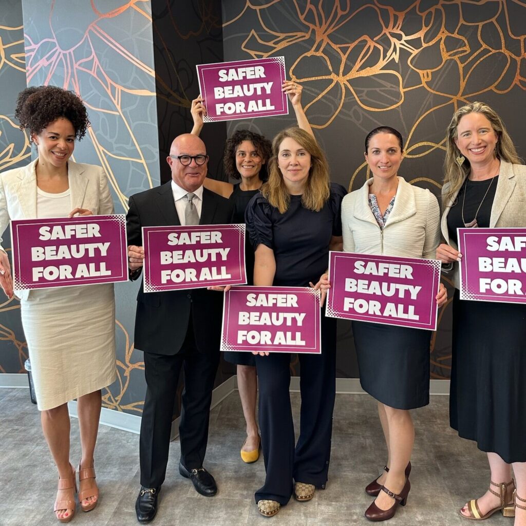 Women holding signs that say Safer Beauty for All